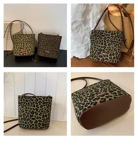 Detail of leopard jacquard bucket bag with smooth leather base and brand label