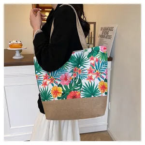 Detail of canvas and jute tote bag featuring tropical floral patterns and large capacity