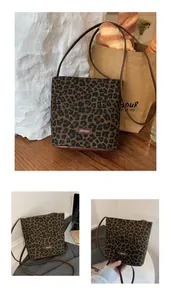 Close-up of leopard print bucket bag featuring FFDVI leather logo and slim strap