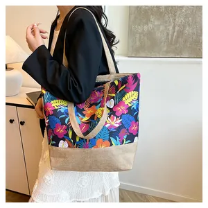 Detail of large tote bag featuring colorful tropical floral patterns and woven canvas base