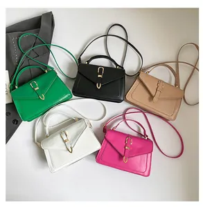Flat lay of small PU leather crossbody bags in five colors with golden buckles
