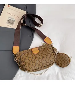 Close-up of brown monogram print three-in-one crossbody bag with wide shoulder strap