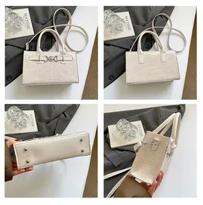 Detailed views of beige crocodile pattern handbag with silver buckle and metal feet