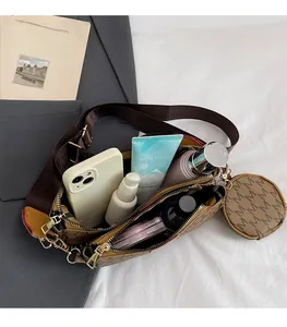 Top view of interior compartments in brown monogram crossbody bag with small round coin purse