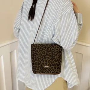 Fashionable leopard print bucket bag for women with texture fabric and crossbody strap