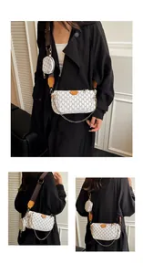 Detail of 3-in-1 crossbody bag with M-pattern print, wide strap, and coin purse