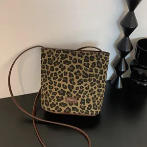 Detail view of leopard print bucket bag with leather trim and FFDVI brand name tag