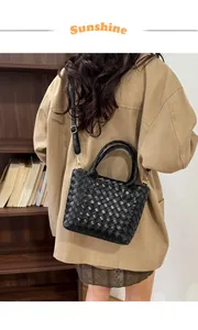 Close-up of black woven PU leather tote bag with adjustable strap on a model