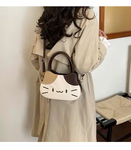 Detailed view of embroidery cat face and color blocking on the shoulder handbag
