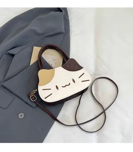 Detailed close-up of a cat-shaped PU leather handbag with animal facial embroidery