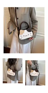 Close-up of cat-themed crossbody bag with embroidery whiskers and ear detail
