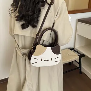 Chic cat-shaped patchwork PU leather handbag with adjustable strap shown on model