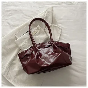 Detailed view of the pleated oil wax leather texture on a deep burgundy tote bag