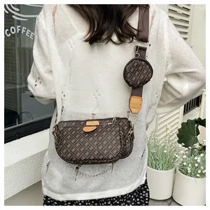 Rear view of a chic three-piece crossbody bag with brown geometric patterns on wide strap