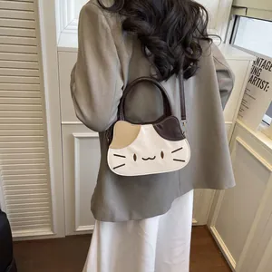 Cute cat-shaped patchwork handbag with top handle and shoulder strap in neutral tones