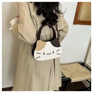 Detailed view of cute cat-shaped tote bag worn by a model in a minimalist setting