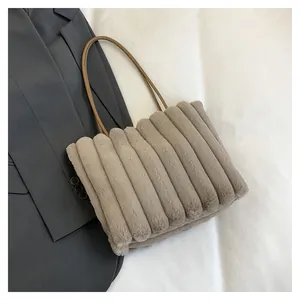 Gros plan détaillé de la texture du cabas en peluche à rayures et lanières en cuir