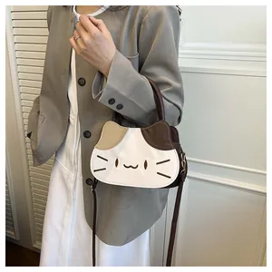 Detail of cute cat shaped crossbody bag with tricolor patchwork and leather handle
