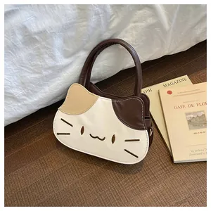 Detail of cartoon cat handbag featuring contrast color stitching and embroidery