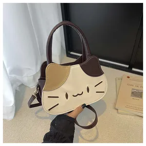 Close-up of cat-shaped crossbody bag with exquisite embroidery and contrast color panels