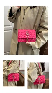 Detail of rose pink quilted crossbody bag with gold chain strap and metal tassel charm