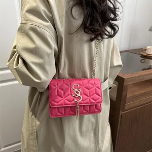 Fashionable rose pink crossbody bag with diamond quilting and gold tassel chain