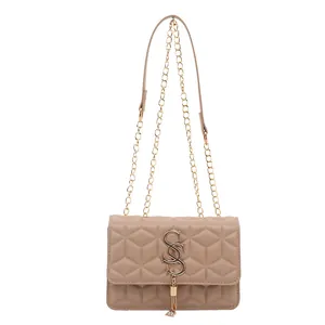 Beige quilted chain shoulder bag with geometric pattern and gold tassel logo detail