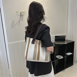 Large woven tote bag with brown and beige stripes for casual commute and daily styling