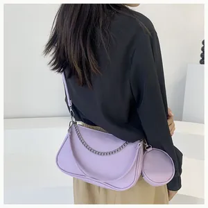 Detail of light purple crescent bag with silver chain and matching round coin purse