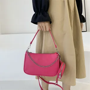 Magenta nylon shoulder bag with silver chain detail and small circular purse