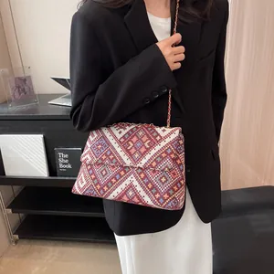 Ethnic style geometric woven crossbody bag with colorful patterns and metal chain strap
