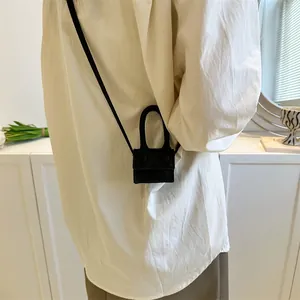 Chic black micro handbag for women with crossbody strap shown on model in modern setting