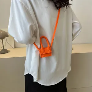 Miniature orange felt crossbody bag with flap and handle for chic summer fashion