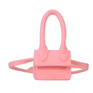 Pink felt mini lipstick bag with exaggerated high handle and long crossbody strap