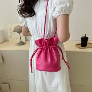 Minimalist rose red drawstring bucket bag for women with elegant faux leather finish