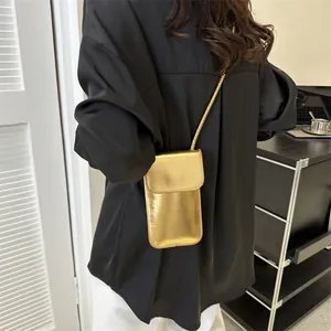 Minimalist metallic gold crossbody phone bag for women with slim strap and flap closure