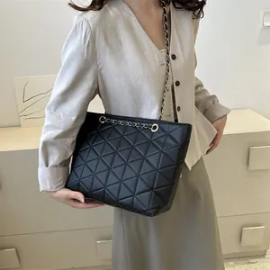 Chic black triangle quilted tote bag with a metallic chain strap for stylish women