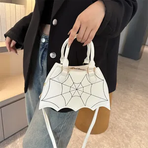 White bat-shaped handbag with spider web pattern and long shoulder strap for women