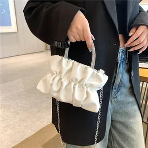 White ruched cloud handbag with sparkling rhinestone handle and silver chain strap