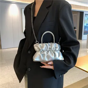 Silver metallic pleated cloud crossbody bag with rhinestone handle and chain strap