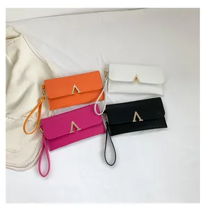 Detail showing four colors of crocodile texture fashion envelopes with gold V buckles