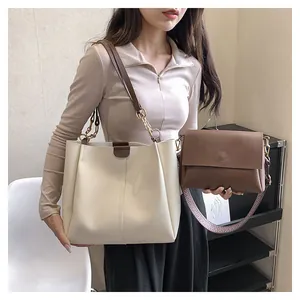 Detail of minimalist tote and crossbody bag set featuring matte PU leather texture