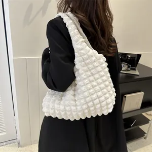 Minimalist white popcorn texture tote bag shown on a model in a modern office setting