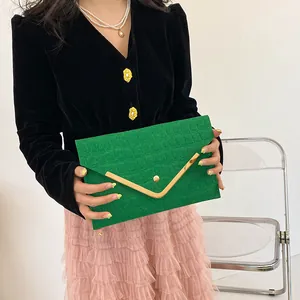 Minimalist green crocodile pattern envelope clutch with gold metal trim and magnetic snap
