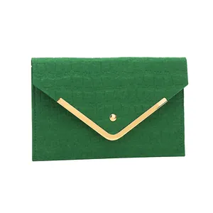 Elegant green crocodile embossed envelope clutch bag with gold metal trim and snap closure