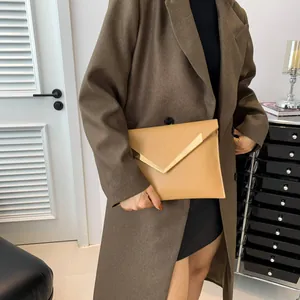 Pochette enveloppe beige minimaliste avec garniture en métal en V et coutures géométriques