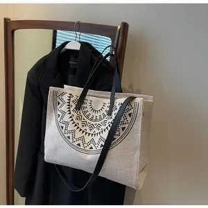 Detailed view of the large off-white canvas tote bag with black geometric print