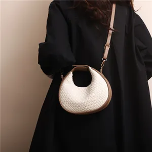 Retro cream woven crescent handbag with dark brown leather trim and gold hardware