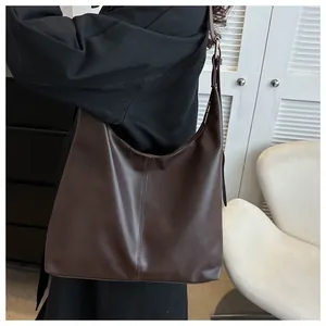 Close-up of deep brown leather hobo bag with elegant vertical stitching details