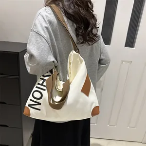 Minimalist beige canvas tote bag with brown straps and fashion print for daily commute